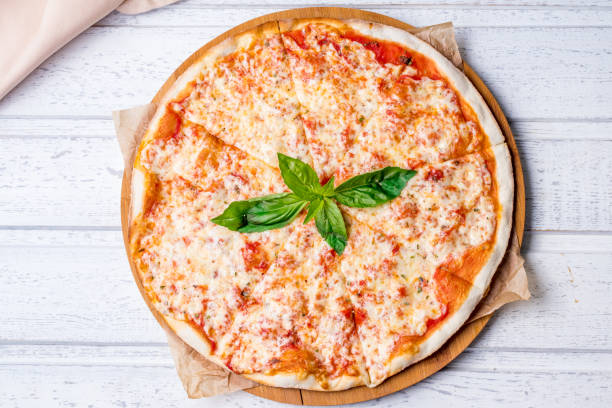 Italian pizza Margherita on white wooden table top view stock photo