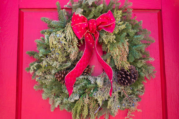 istock Green Christmas Wreath on Red Door 1371856013