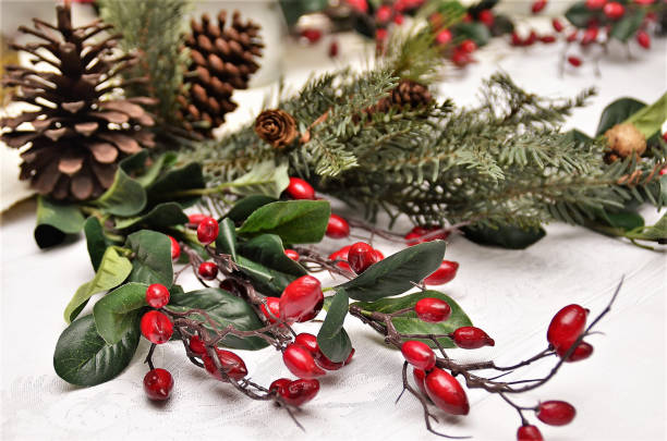 istock Arrangement with red berries and pine over desk 1371857614