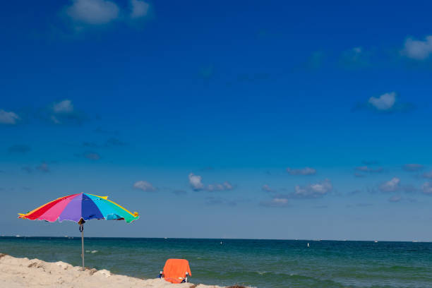 istock Empty beach chair with umbrella facing the seashore 1371861848