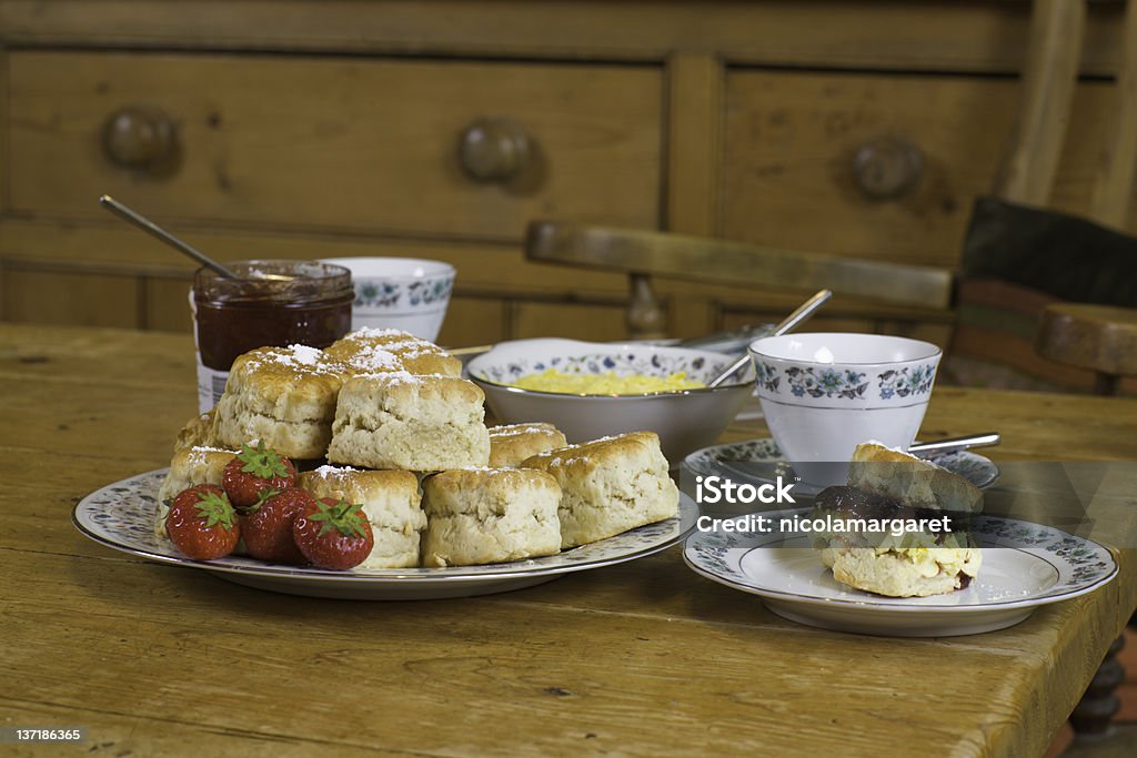 English cream tea: eye level Traditional Devonshire clotted cream tea with strawberry jam UK Stock Photo