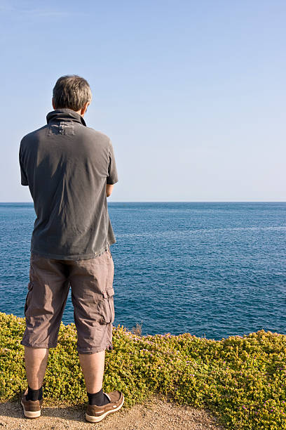 istock Man gazing at blue, sparkling sea 137186393