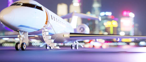 istock Private jet parked on runway over blurred city night lights in the background. 1371864151