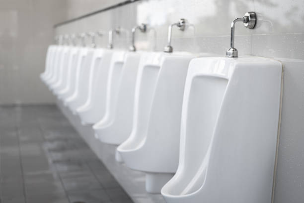 row of gentlemen urinals toilet. - urinal clean contemporary in a row imagens e fotografias de stock