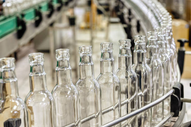 istock Conveyor belt carries clean glass bottles for alcohol drinks 1371872356