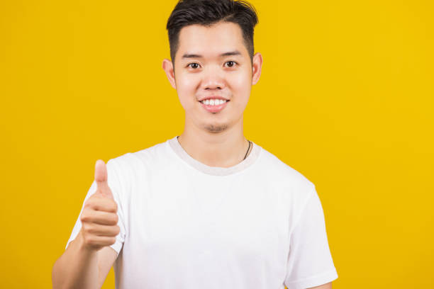 istock man smiling positive showing thumbs up gesture 1371873315