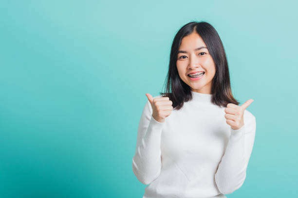 istock woman cheerful smiling showing finger thumb up 1371873330
