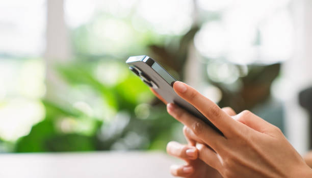 istock Hand holding smartphone and chatting online on mobile, During leisure time. 1371879741