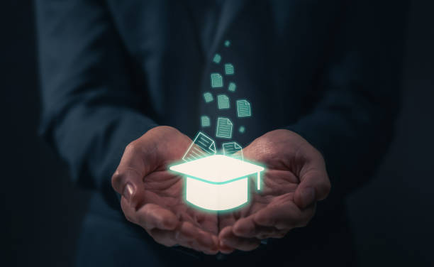 istock Businessman hand holding graduation cap with document, Education and Innovative learning Concept. 1371879769