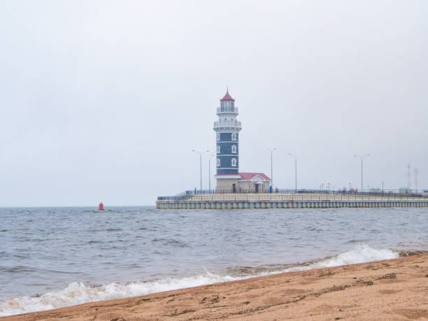 istock Beacon, seashore, beach, sand, wave, water, sky and Lighthouse in fog 1371879854