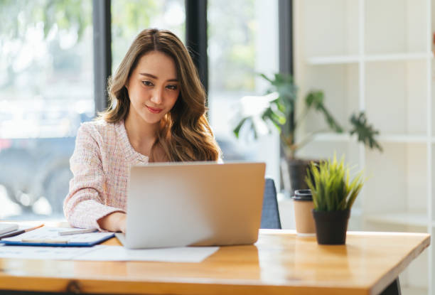 istock Smiling young manager working on promising project with help of laptop while sitting at cozy coffeehouse, blurred background 1371880613