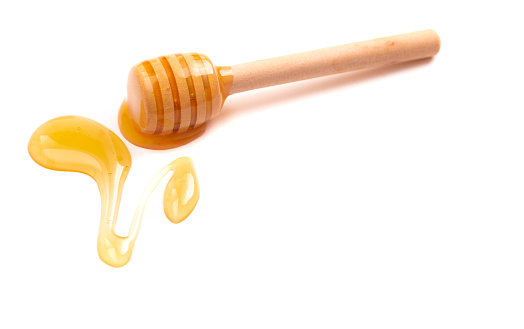 Honey Spoon and Honey Isolated on a White Background