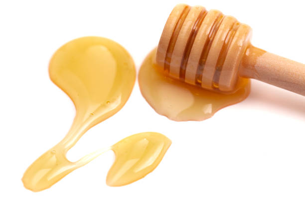 istock A Honey Spoon and Honey Isolated on a White Background 1371880817