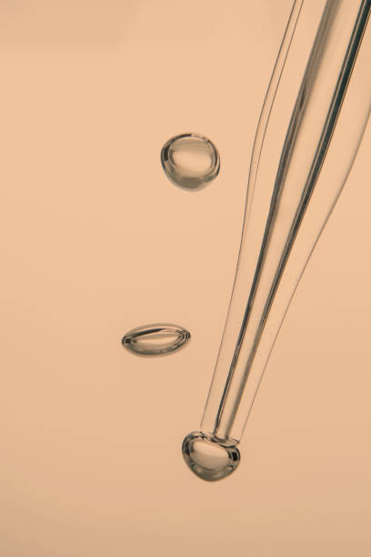 istock Pipette with cosmetic product in water with bubbles. 1371882439