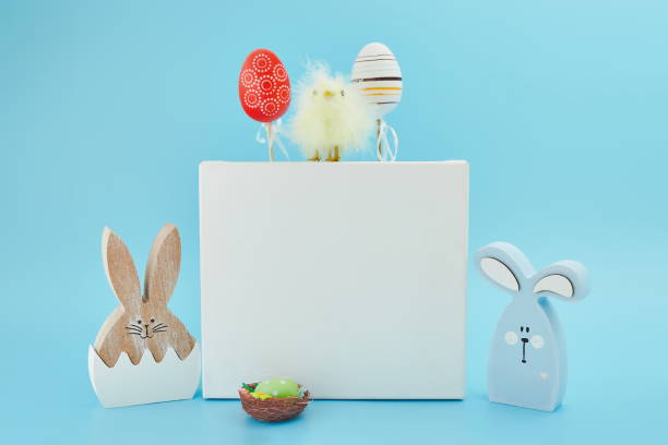 istock Creative Easter  eggs, feathers in a nest on a blue  background. The minimal concept.  Card with a copy of the place for the text. 1371886248