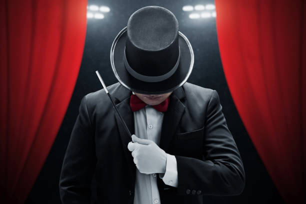 istock Magician holding magic wand on stage 1371886283
