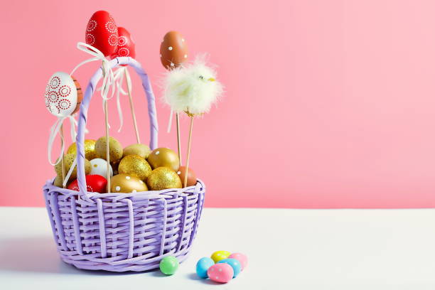 istock Easter colored eggs in a basket  pink background. Minimal concept. Card with copy space for text. Easter Decoration chick, rabbit 1371886403
