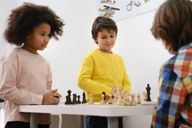 istock multiethnic kids playing chess board game at school 1371887351