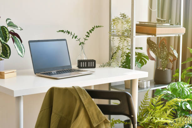 istock Home office decorate with green nature tree plants, Workspace and laptop computer on desk, Artificial houseplant for home and living room interior. 1371889872