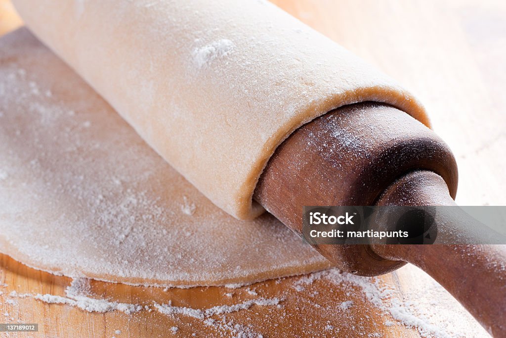 stretched dough with a rolling pin stretched dough with a rolling pin and flour Bakery Stock Photo