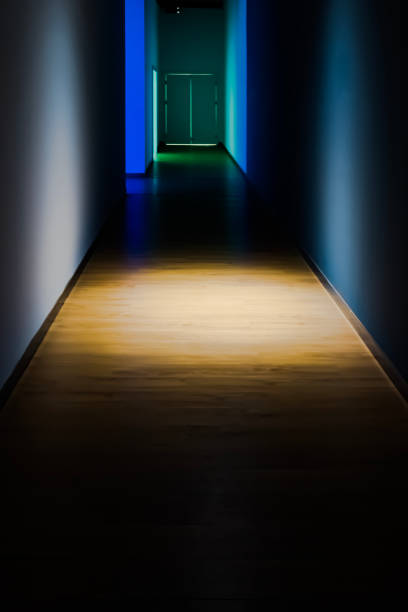a beam of light falls from above in a dark corridor, an area of the floor of the corridor is illuminated - illuminated vertical shadow focus on shadow imagens e fotografias de stock