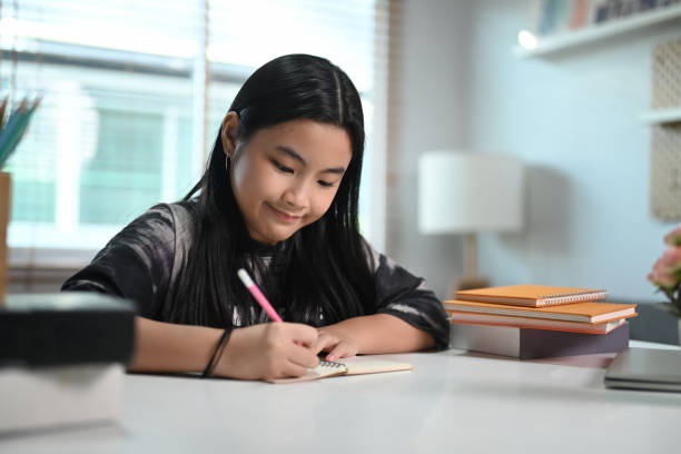 istock Happy elementary school student  doing homework in living room. 1371892749
