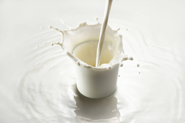 istock milk pouring into glass with splashes on white background 1371893064