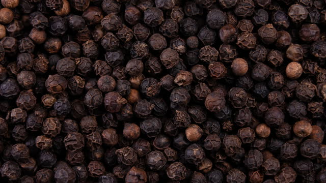 Black peppercorn rotating with close up