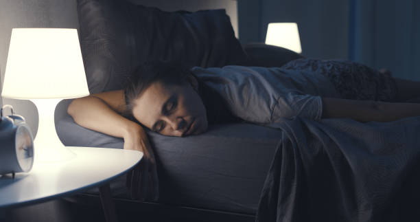 istock Woman sleeping in her bed at night 1371893853