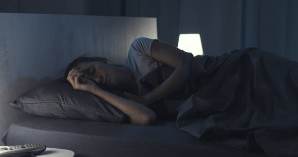 istock Woman sleeping in her bed at night 1371894140