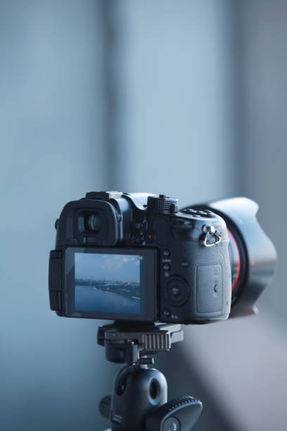 istock photo camera mounted on a tripod close-up 1371894173