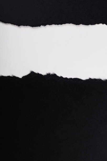 istock Black paper with torn edges isolated with white colored paper background inside. Good paper texture 1371895046