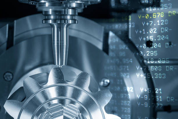 istock The abstract scene multi-axis machining center cutting the metal gear part and NC data background. 1371896830