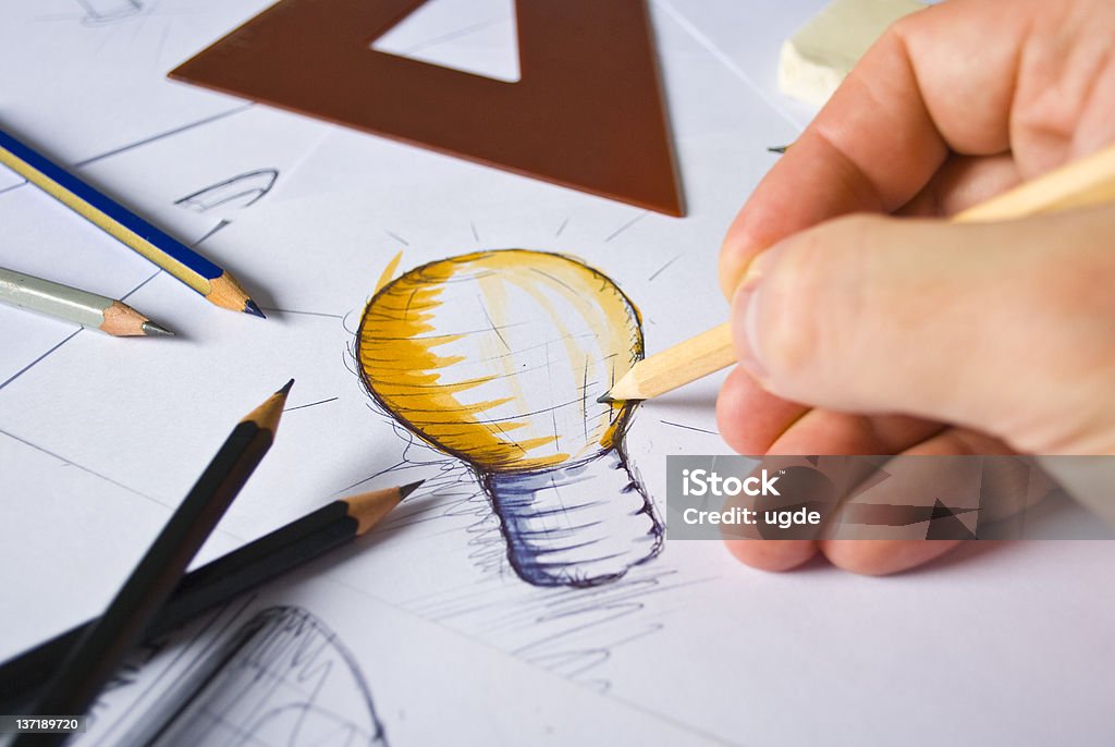Designer Drawing A designer drawing sketches Graphic Designer Stock Photo