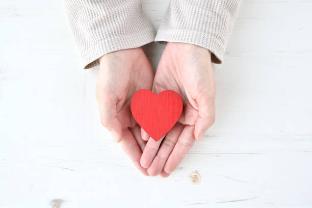 istock Female hands covering heart object 1371899061