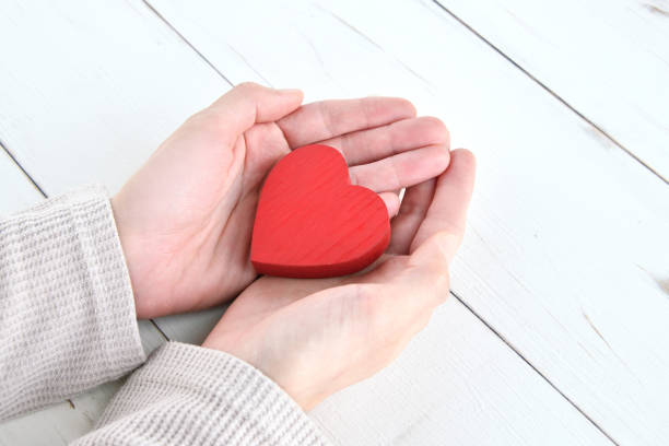 istock Female hands covering heart object 1371899096