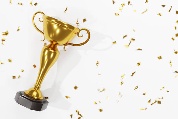 winners golden cup and confetti isolated on white background - copy space single object confetti nobody imagens e fotografias de stock