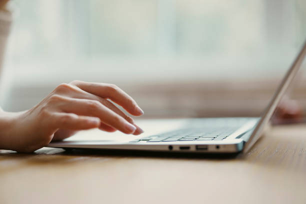 istock Close up of woman's hands typing on laptop 1371900710