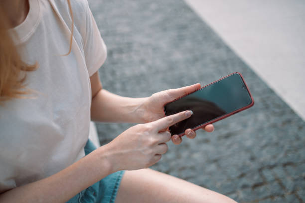 istock Tourist female using smartphone mobile app to text sms while traveling 1371901749
