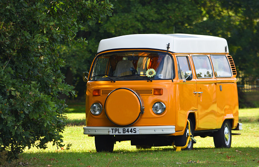 Ickwell, Bedfordshire, England - September 01, 2019: Classic Orange VW Camper Van parked on village green.