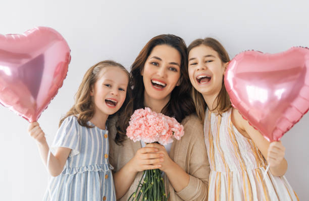 istock daughters are congratulating mother 1371902853