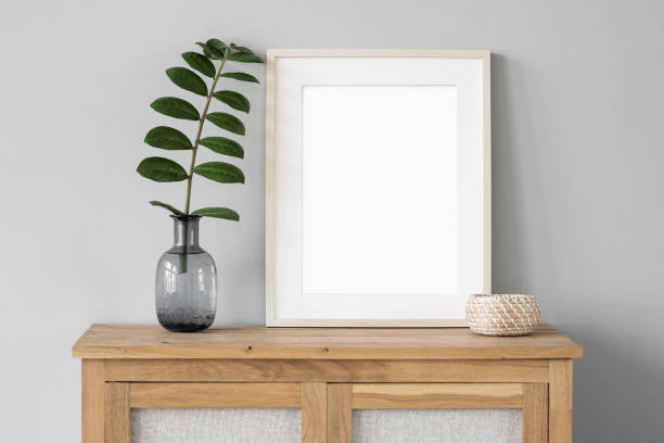 istock Artwork mock-up in interior design. Blank white vertical picture frame on a cupboard 1371902950