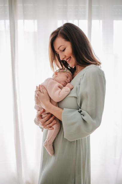 istock Mother holding a newborn baby 1371903236