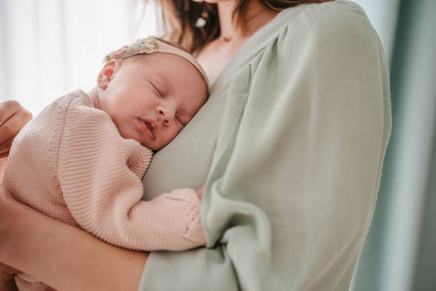 istock Mother holding a sleeping newborn baby 1371904674