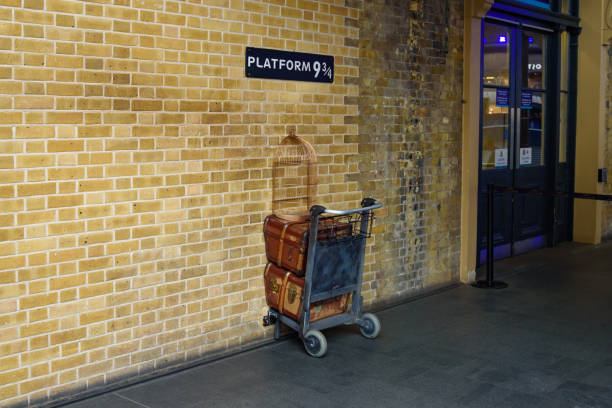 harry potter"u2019s bahnsteig 93/4 im bahnhof king's cross in london, vereinigtes königreich - harry potter kunstwerkname stock-fotos und bilder