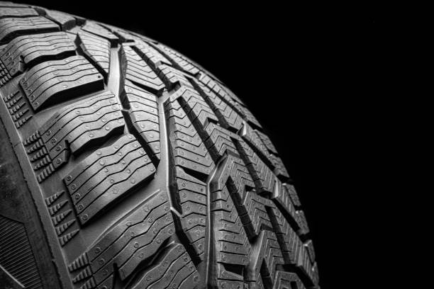 istock black isolation rubber tire, on the black backgrounds 1371907178
