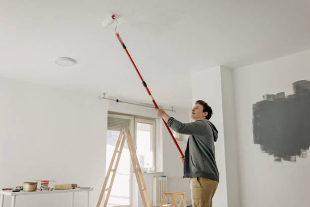 istock Teenager painting the ceiling 1371909054