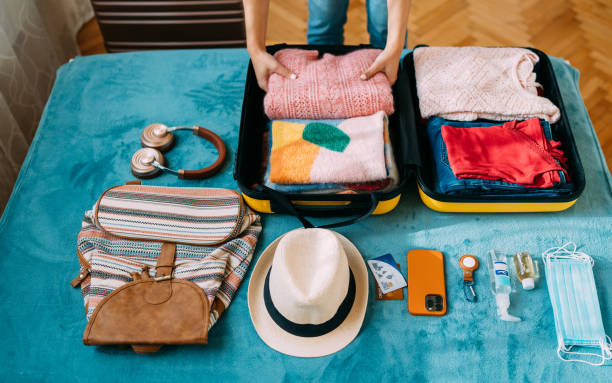 istock Woman packing suitcase for travel 1371909195