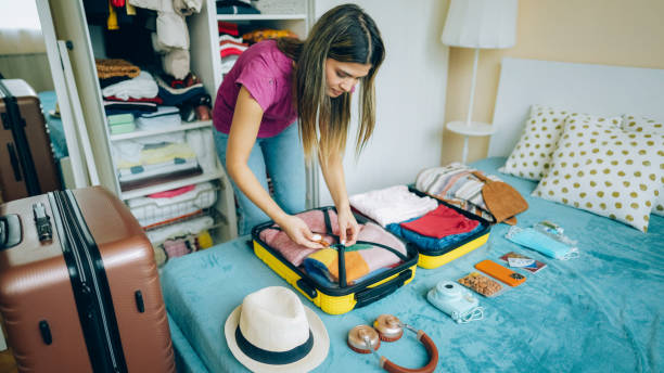 istock Woman packing suitcase for travel 1371909238