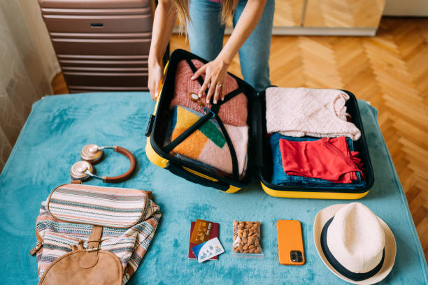 istock Woman packing suitcase for travel 1371909298